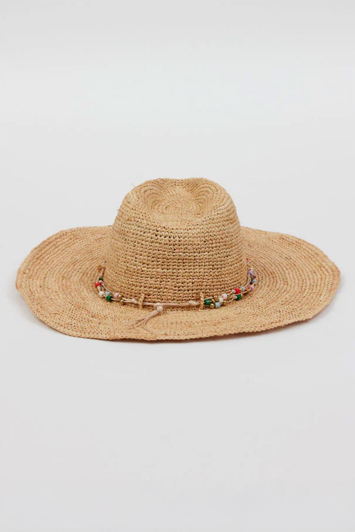 The MILL CONTINENTAL HAT by Velvet by Graham & Spencer is a wide-brimmed straw hat featuring a beaded band around the crown, showcased against a plain background.