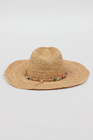The MILL CONTINENTAL HAT by Velvet by Graham & Spencer is a wide-brimmed straw hat featuring a beaded band around the crown, showcased against a plain background.