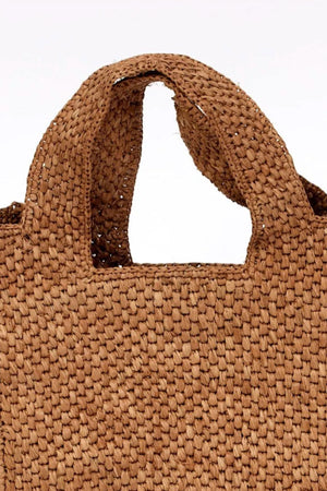 Close-up of the MINI LULU TOTE by Velvet by Graham & Spencer, featuring a brown woven design with two handles.