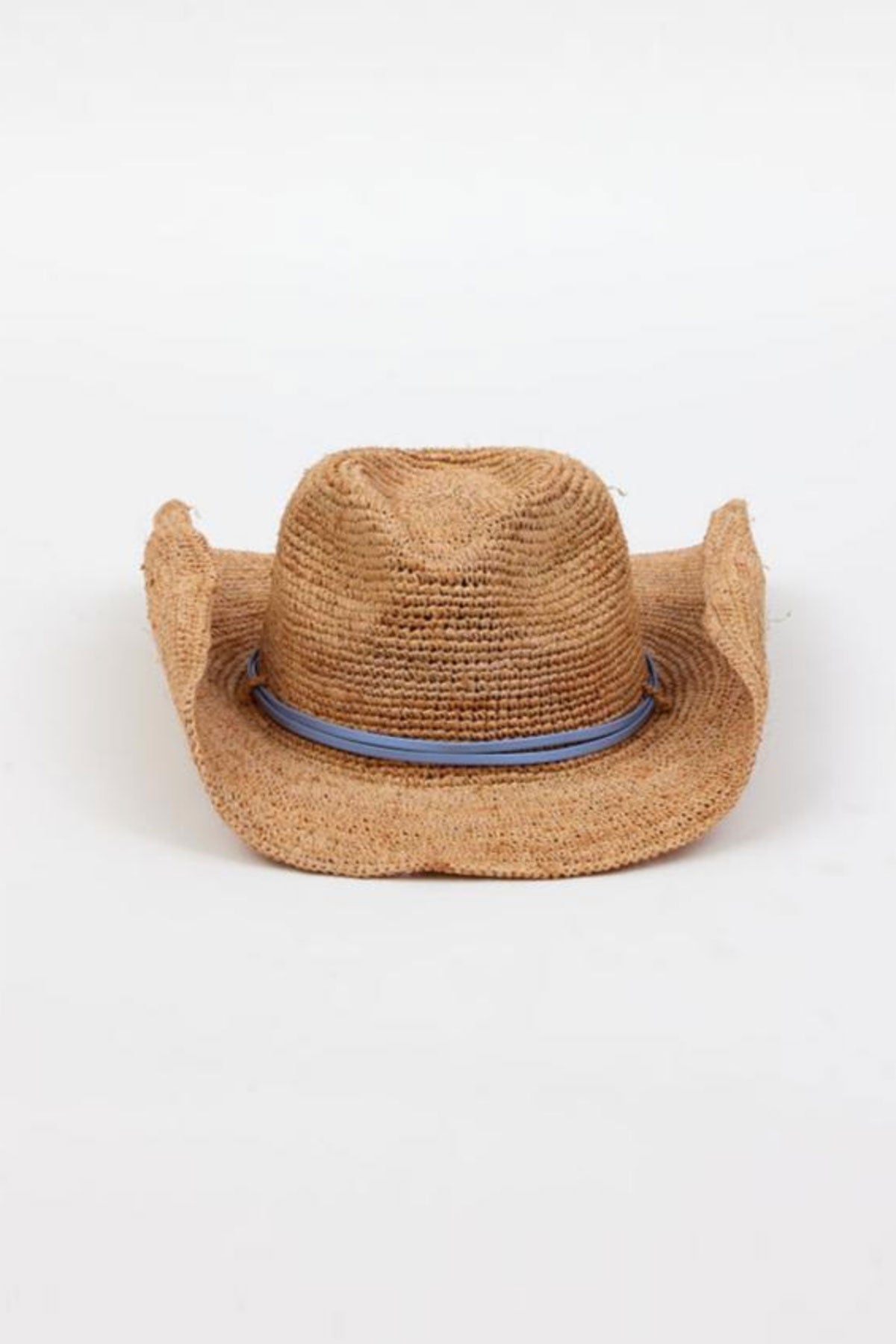 The RAFFIA CROCHET COWBOY HAT by Velvet by Graham & Spencer exudes western charm with its light blue band and slightly worn appearance, set against a plain white background.