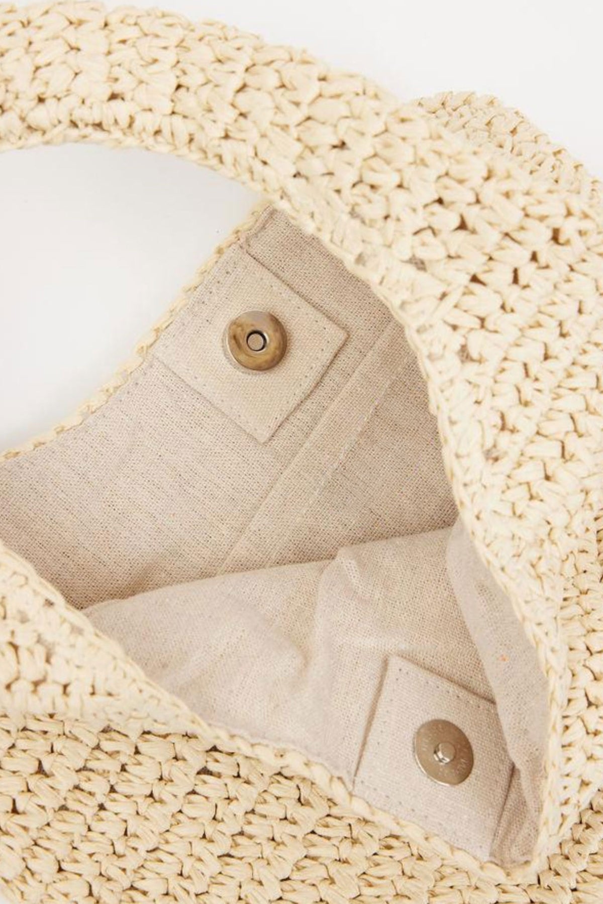 The SHELLY BAG by Velvet by Graham & Spencer is an open woven straw bag featuring a magnetic snap closure and a linen interior.-39027314950337