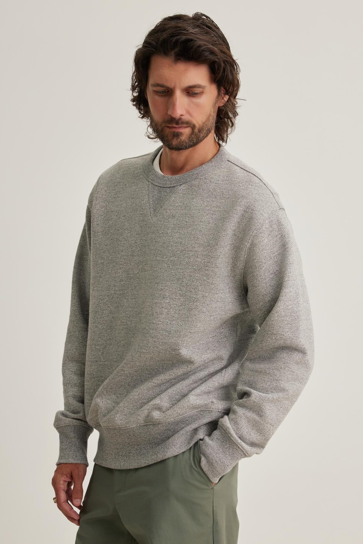 A person wearing a HAMES SWEATSHIRT by Velvet by Graham & Spencer and olive pants stands against a neutral background.-38643296731329