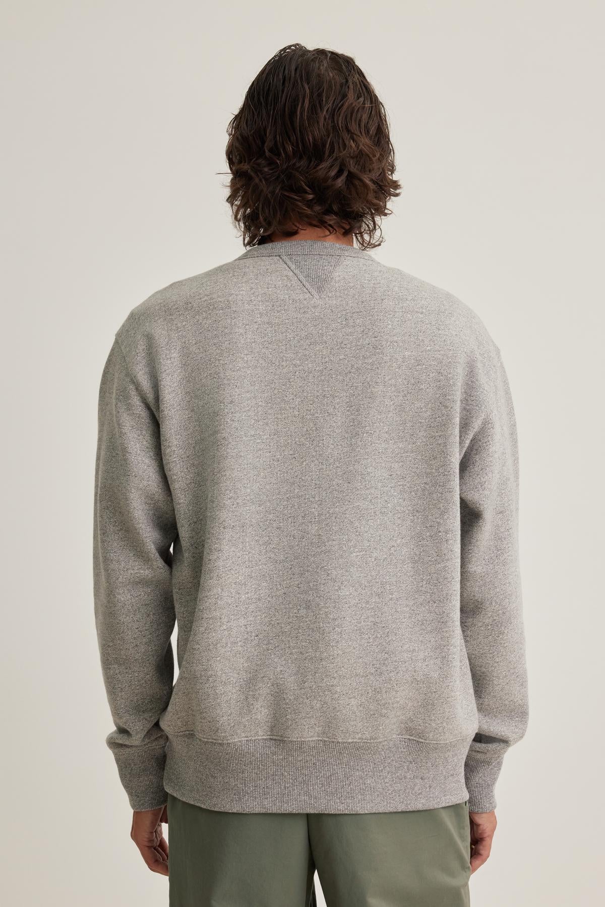 A person with medium-length hair is seen from the back, wearing a HAMES SWEATSHIRT by Velvet by Graham & Spencer and green pants.-38643296698561