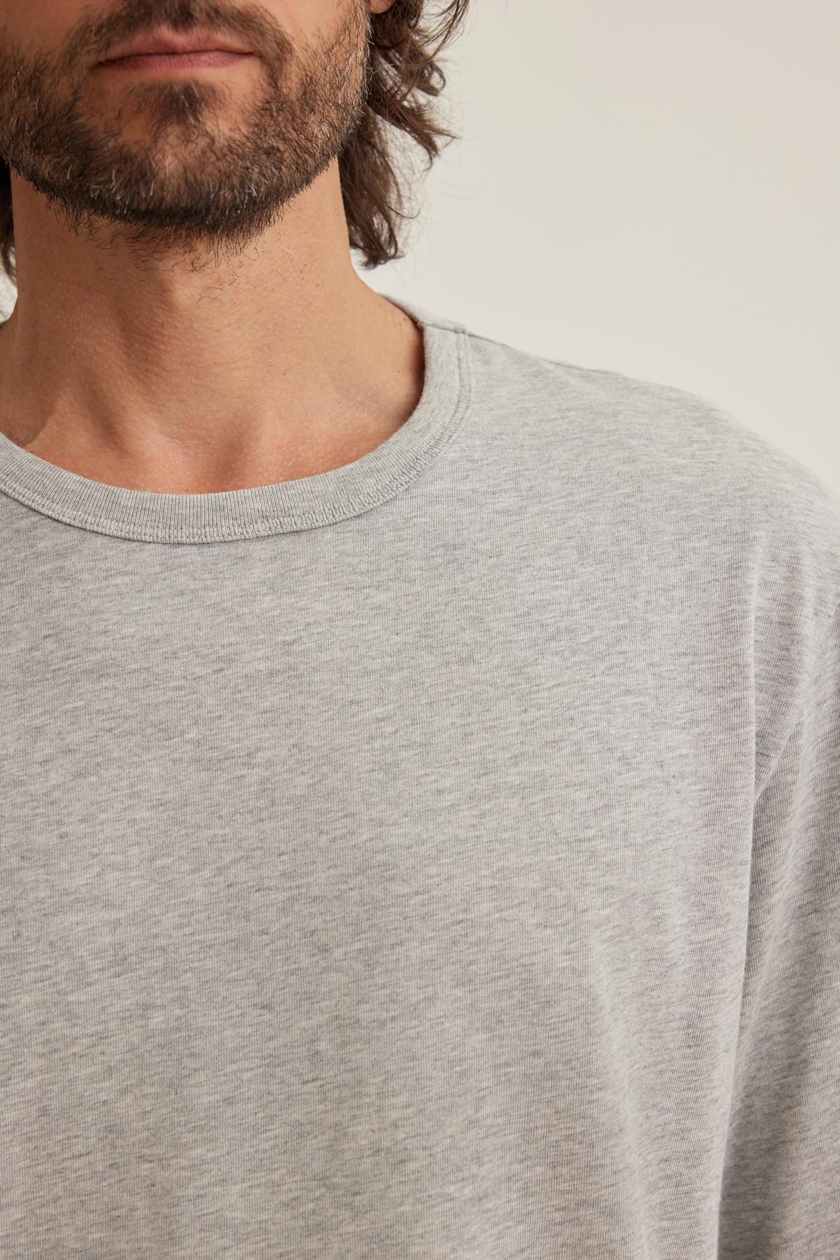 A person with a beard wearing the Velvet by Graham & Spencer EVREN TEE in light gray is partially visible against a neutral background.
