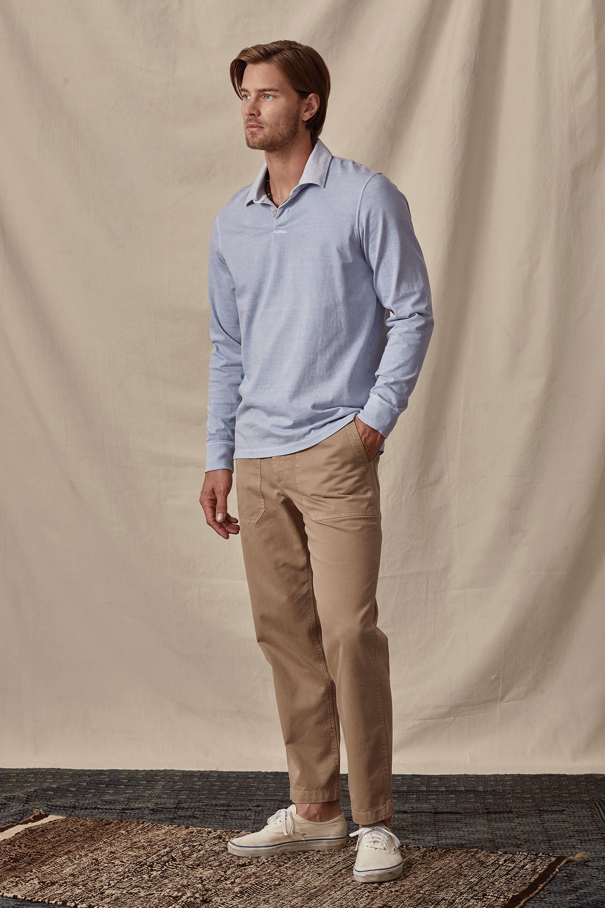   A man wearing a Velvet by Graham & Spencer BALTHAZAR HEAVY JERSEY POLO shirt and khaki pants. 
