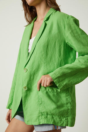 a woman wearing a green Velvet by Graham & Spencer CASSIE HEAVY LINEN BLAZER.