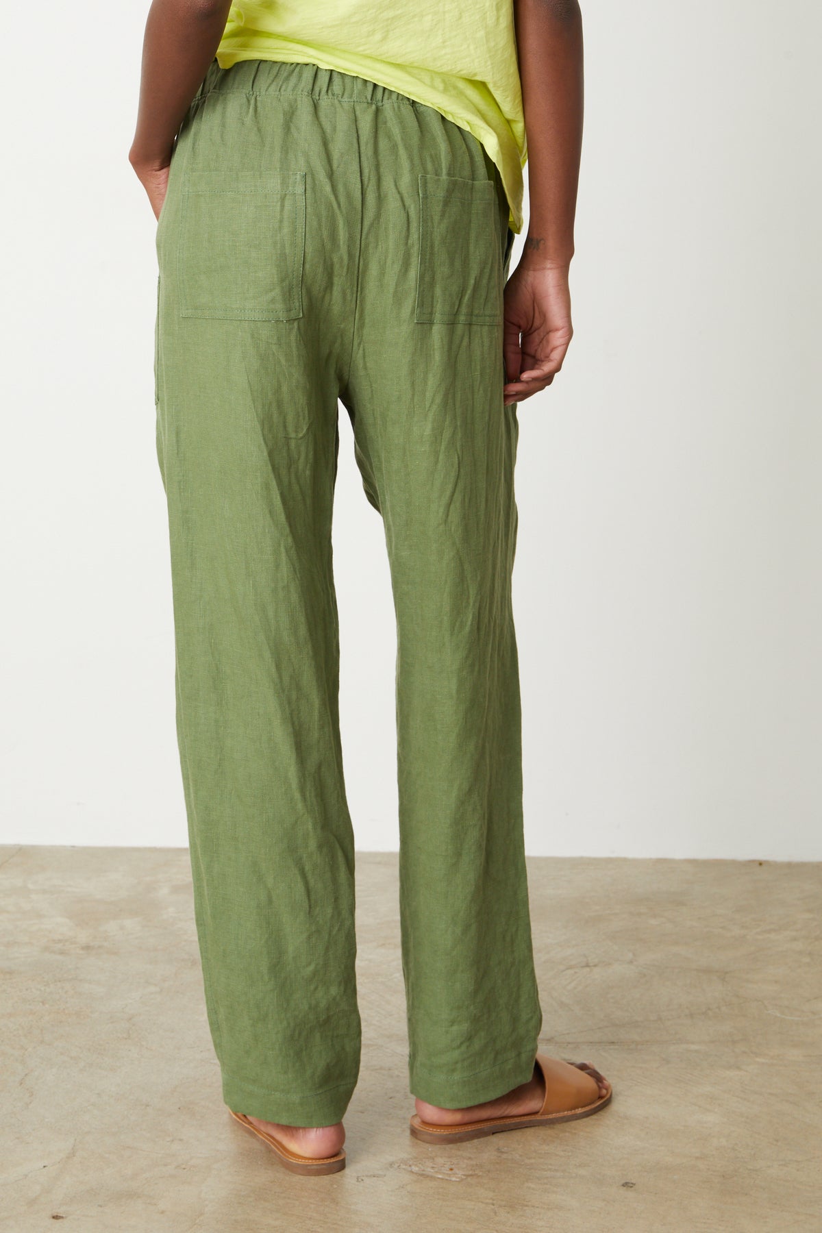 The back view of a woman wearing Velvet by Graham & Spencer's CINDY HEAVY LINEN PANT.-26757364285633