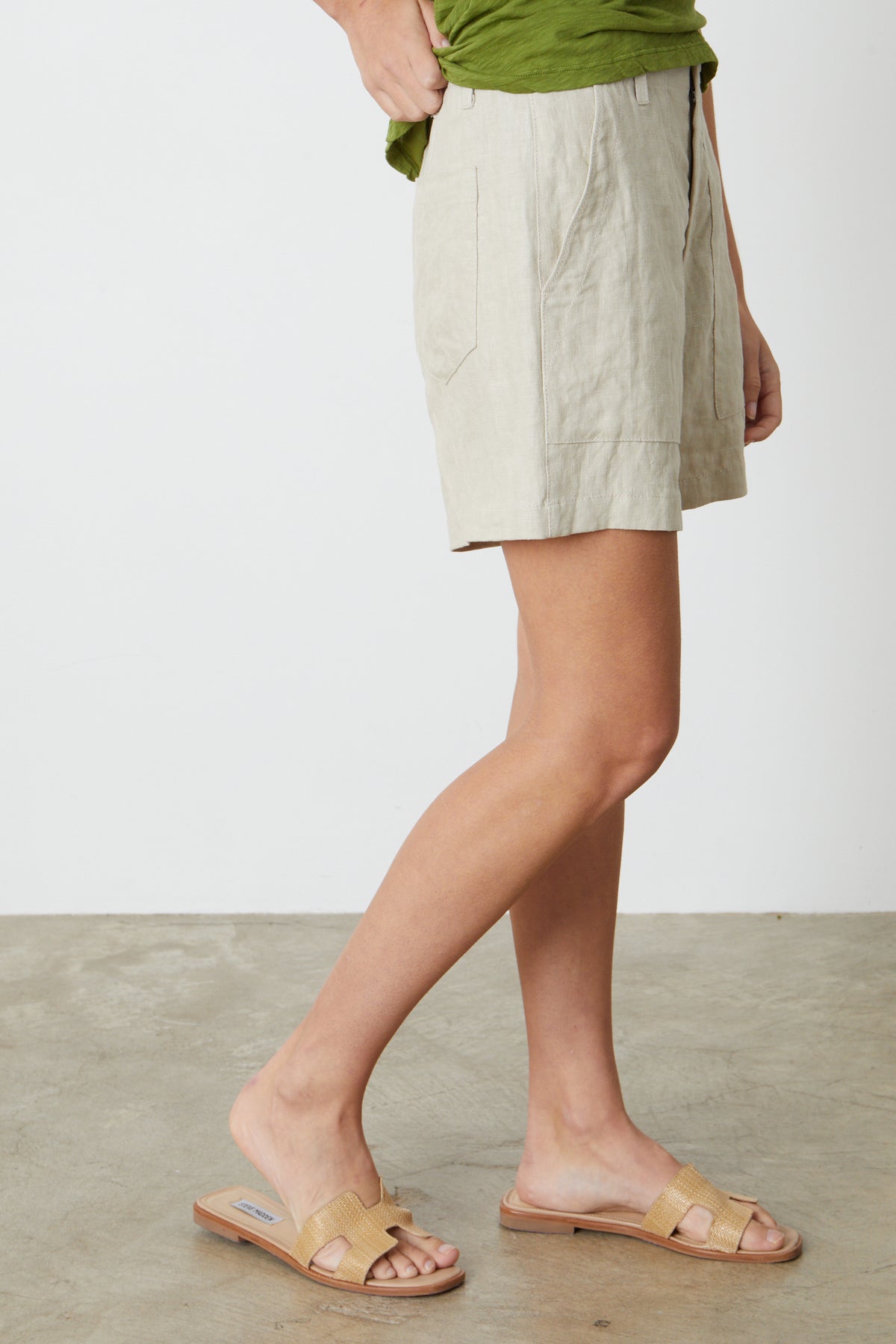 a woman wearing a green shirt and Velvet by Graham & Spencer's FALLON HEAVY LINEN SHORT.-26485847228609