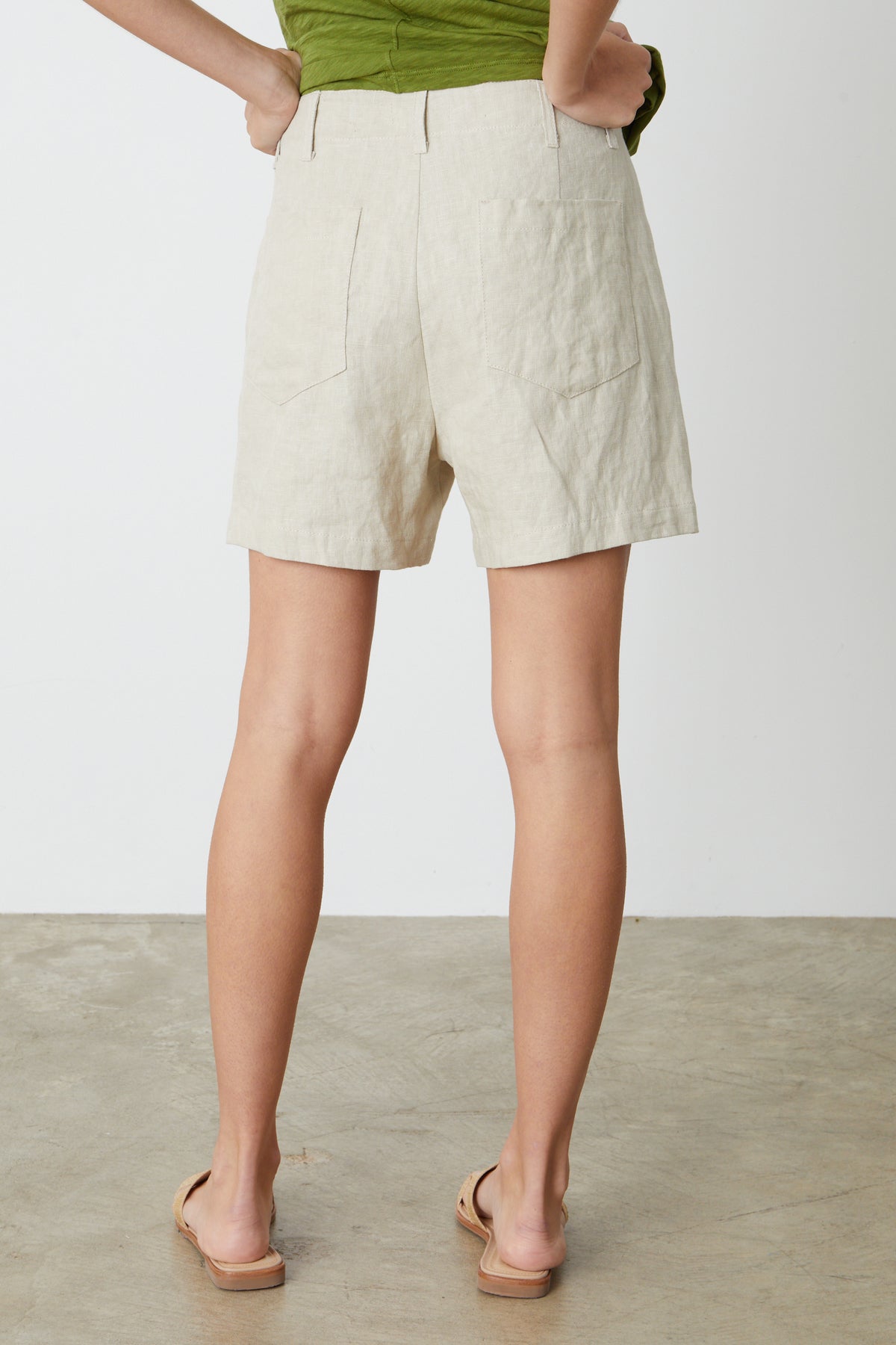 The back view of a woman wearing Velvet by Graham & Spencer's FALLON HEAVY LINEN SHORT.-26485847261377