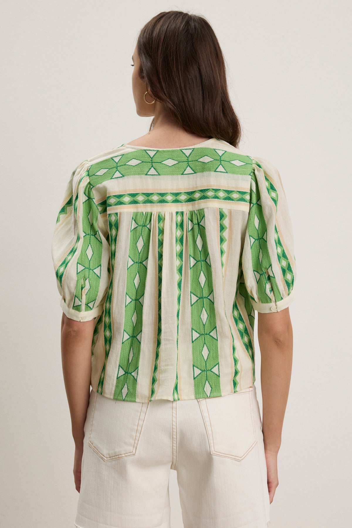 A person is shown from the back wearing the short-sleeved, green and cream MARISSA TOP by Velvet by Graham & Spencer, a cotton jacquard blouse with vertical stripes, paired with white high-waisted shorts.