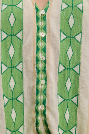 Close-up of the MARISSA TOP by Velvet by Graham & Spencer, a cotton jacquard V-neck with vertical green and white geometric patterns, puff sleeves, and a row of white center buttons.