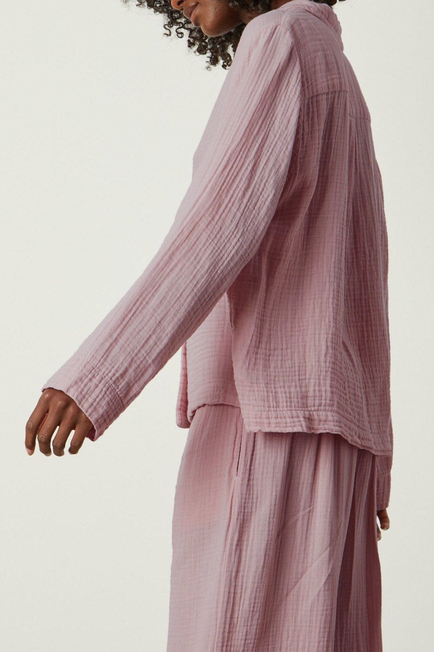 a woman wearing a pink long-sleeved Jenny Graham Home PAJAMA SHIRT and pants.