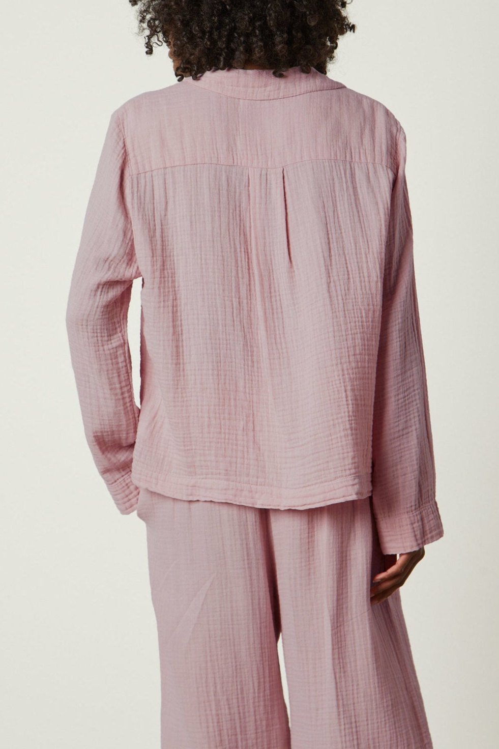 the back view of a woman in a Jenny Graham Home pink PAJAMA SHIRT.