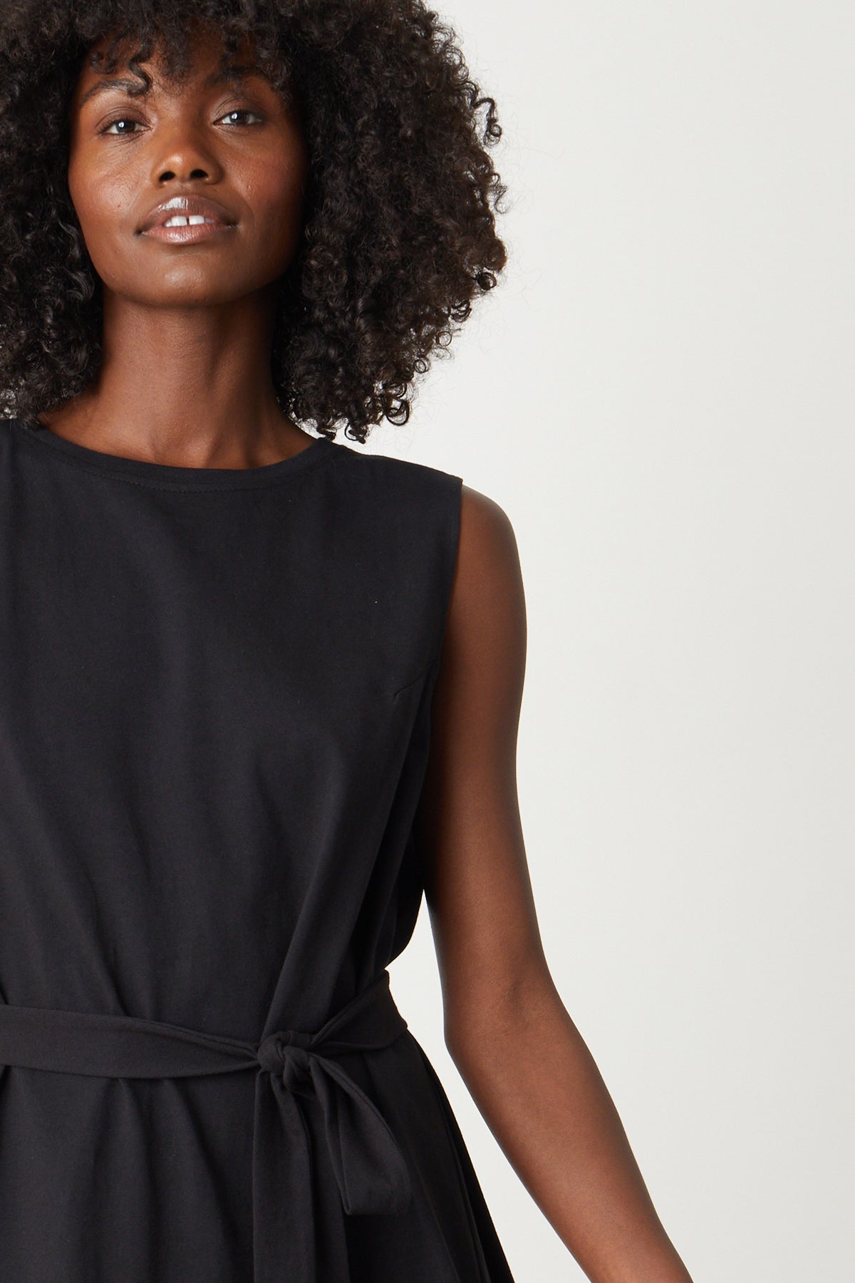 A woman wearing a LAINE STRUCTURED TANK DRESS by Velvet by Graham & Spencer with a belt.-26342718701761