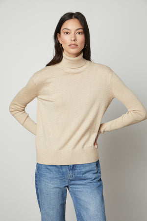 A model wearing a Velvet by Graham & Spencer SALLY MOCK NECK SWEATER.
