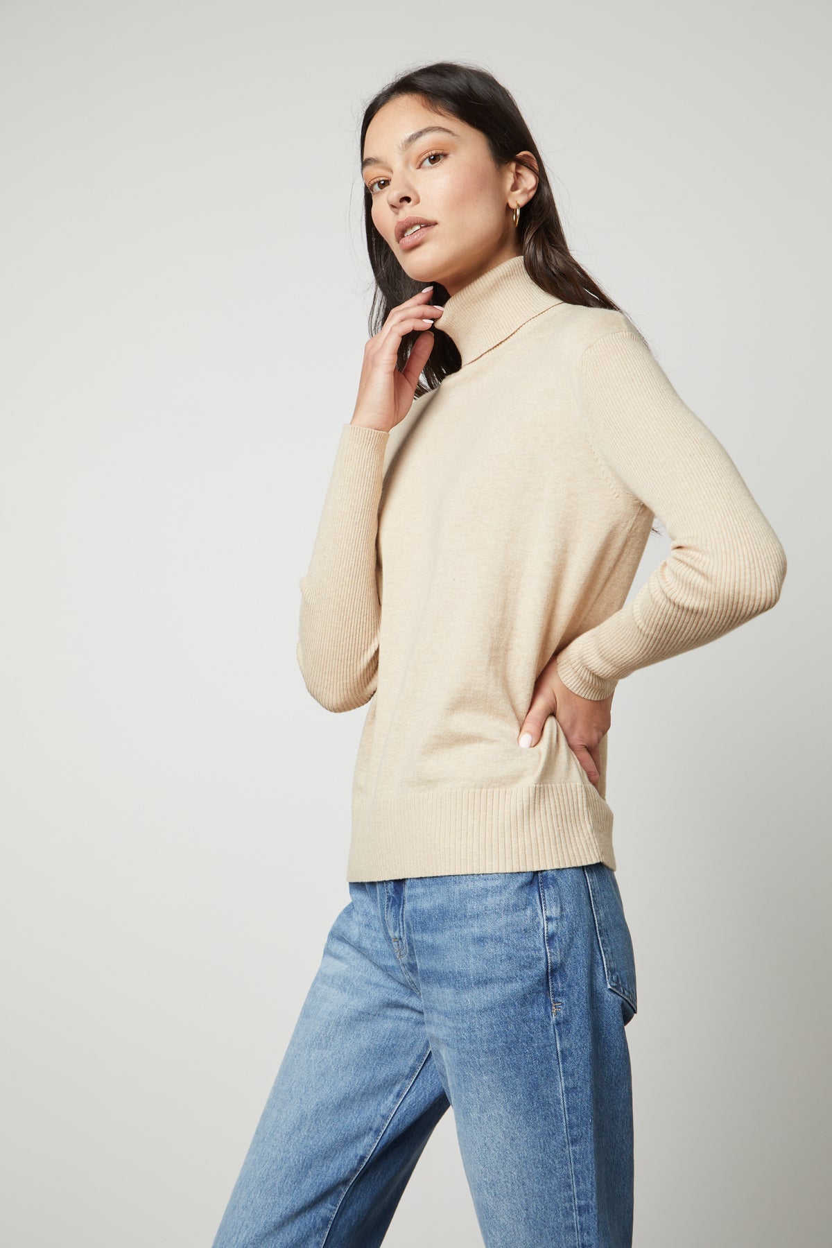 The model is wearing a Velvet by Graham & Spencer SALLY MOCK NECK SWEATER.-35430894076097