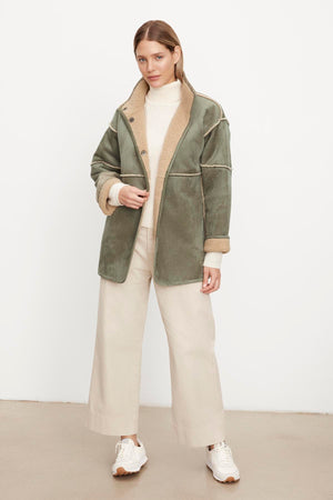 The model is wearing a Velvet by Graham & Spencer ALBANY LUX SHERPA REVERSIBLE JACKET.