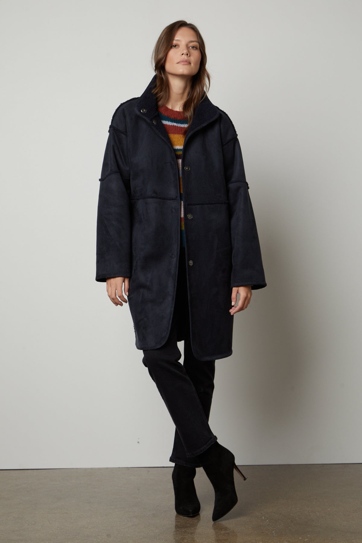 A woman wearing a Velvet by Graham & Spencer CARA LUX SHERPA REVERSIBLE JACKET and striped tee.-26897578787009