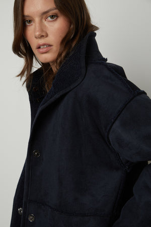 The model is wearing a Velvet by Graham & Spencer CARA LUX SHERPA REVERSIBLE JACKET.