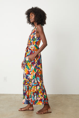 A woman wearing a colorful Velvet by Graham & Spencer Estelle Printed Linen Dress.