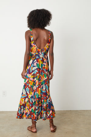 The back view of a woman wearing a ESTELLE PRINTED LINEN DRESS.
