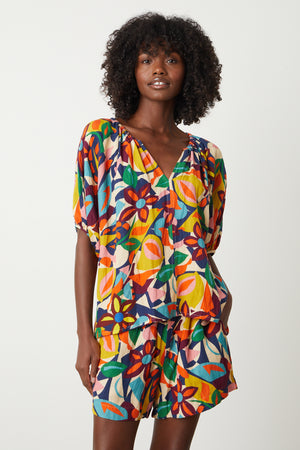 A woman wearing a Velvet by Graham & Spencer ROBIN PRINTED LINEN TOP and shorts.
