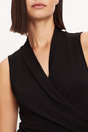 A woman wearing a Velvet by Graham & Spencer DORTHY WRAP TANK TOP with a v - neck.