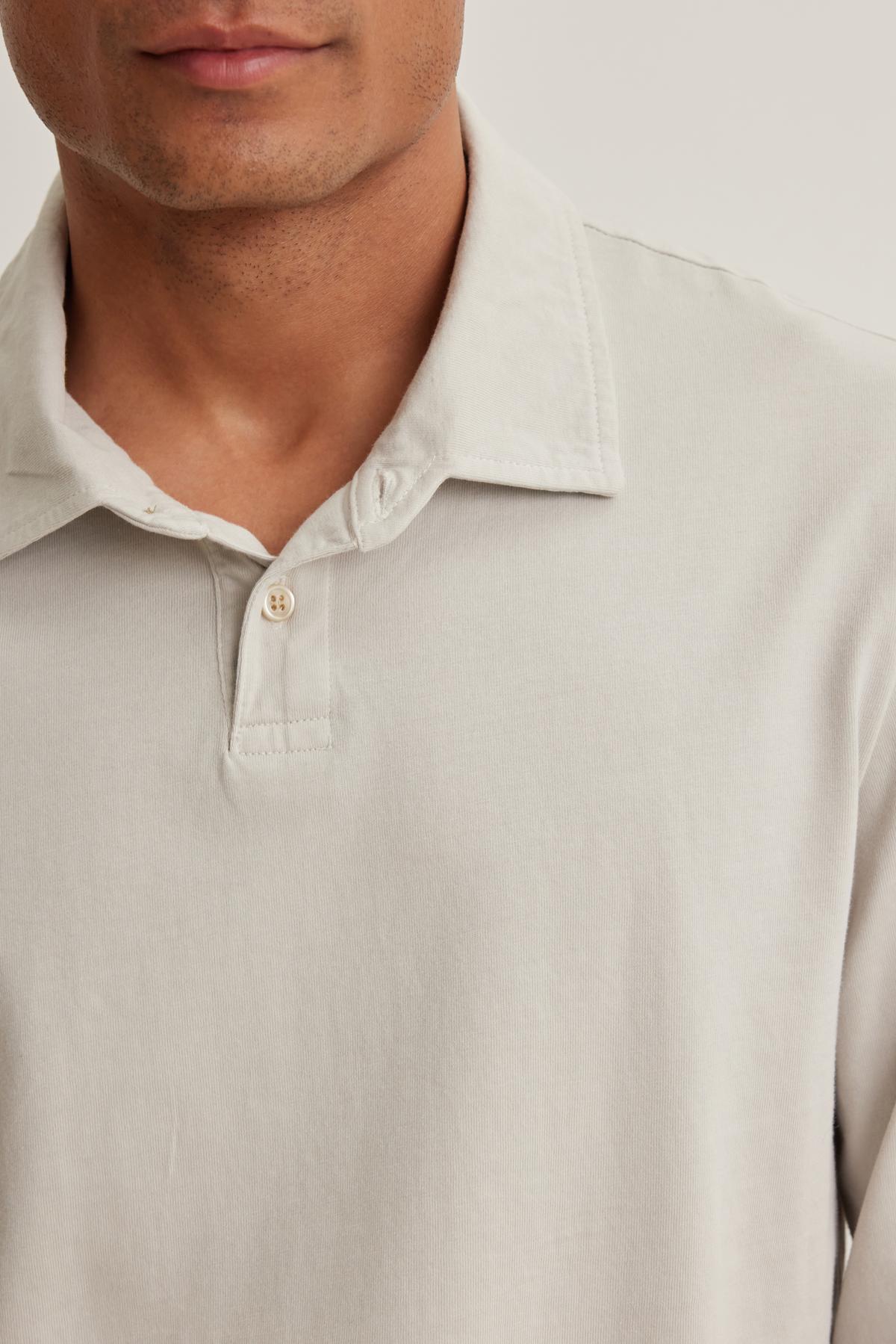 The head is partially visible in a person wearing the FLINT POLO, a beige collared, button-up shirt by Velvet by Graham & Spencer.-38643288572097