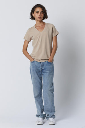 The model is wearing a classic Velvet by Jenny Graham RUNYON TEE and blue jeans.
