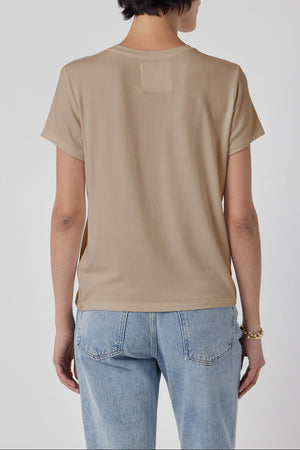 Woman wearing a classic Velvet by Jenny Graham SOLANA TEE and blue jeans standing with her back to the camera.