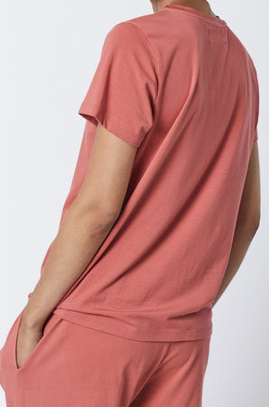 The back view of a woman wearing a Velvet by Jenny Graham SOLANA TEE pink t-shirt and pants.