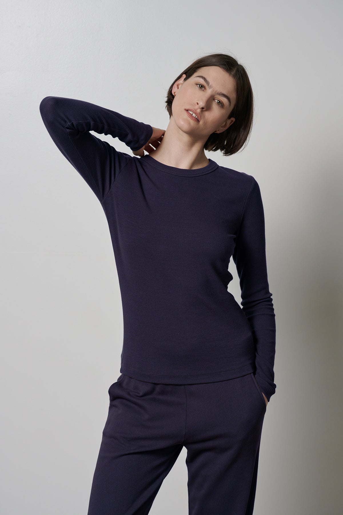 The model is wearing a super soft navy long-sleeved CAMINO TEE and pants that offer ultimate comfort by Velvet by Jenny Graham.-35547425734849
