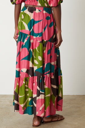 The back view of a woman wearing a Velvet by Graham & Spencer LYDIA PRINTED TIERED SKIRT.