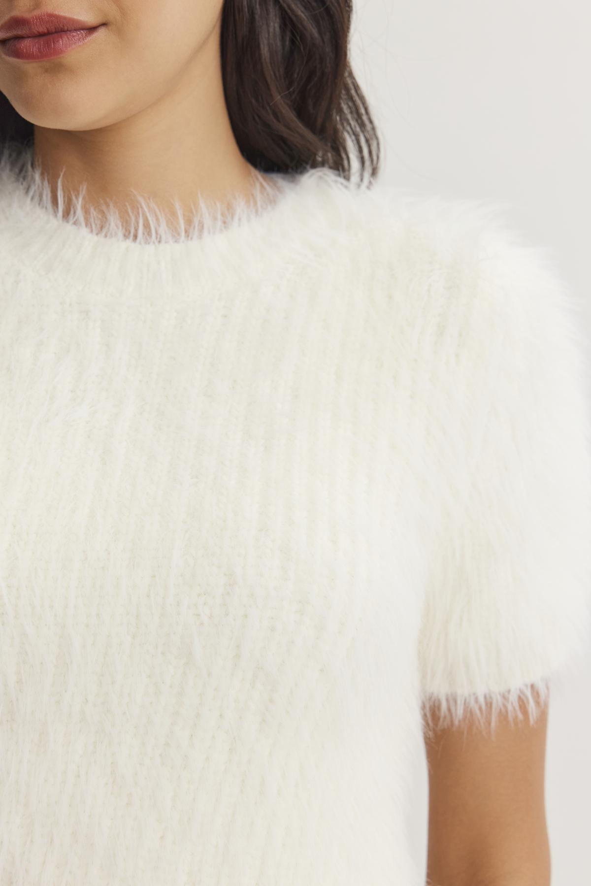 A woman is wearing the EILA FEATHER YARN SWEATER by Velvet by Graham & Spencer, with only her shoulder and part of her face visible.-38246411698369