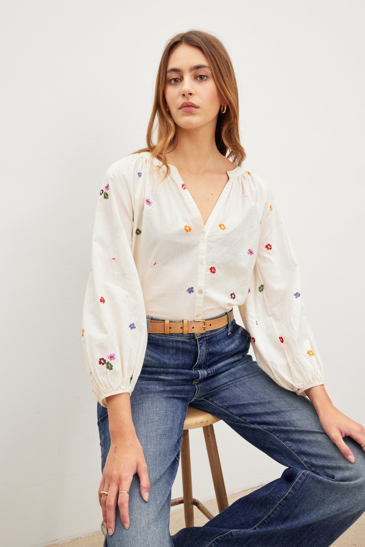 The model is wearing a white Velvet by Graham & Spencer blouse with embroidered flowers.-35955612582081