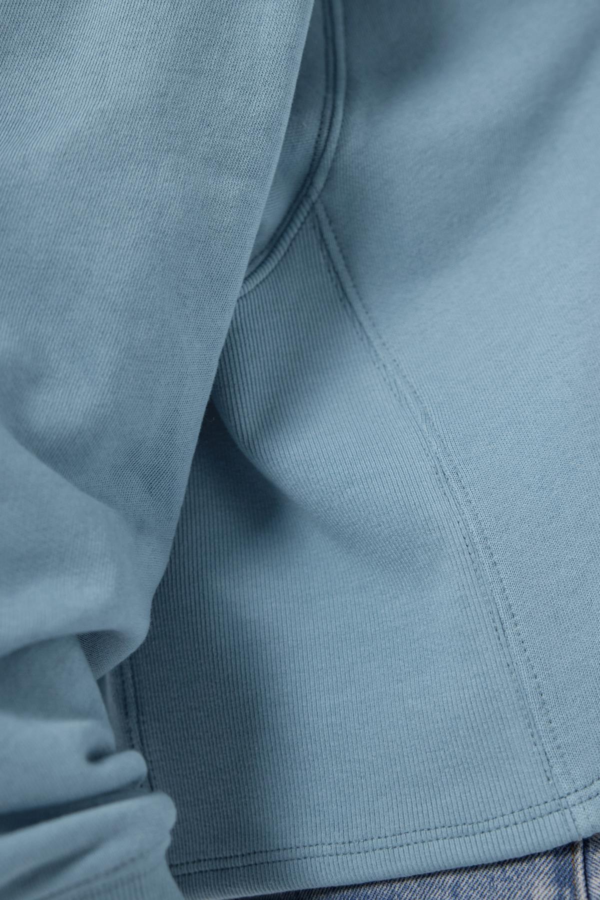 A close up of a blue cropped MALIBU SWEATSHIRT by Velvet by Jenny Graham.-36168705310913