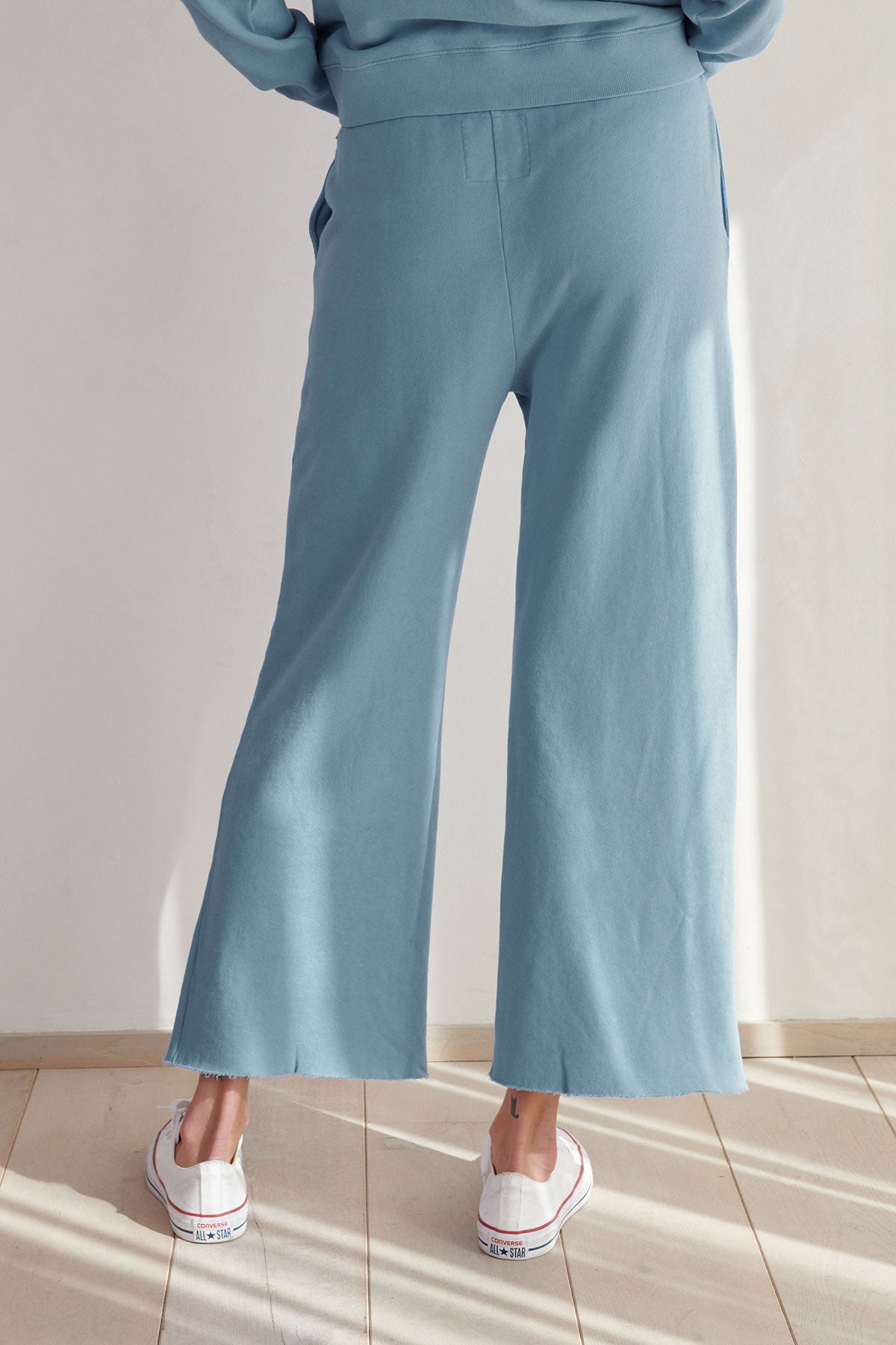 Description: The back view of a woman wearing Velvet by Jenny Graham's MONTECITO SWEATPANT.-36212537721025
