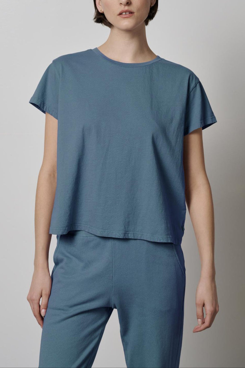 The model is wearing a Velvet by Jenny Graham TOPANGA TEE and blue pants.-35721216819393