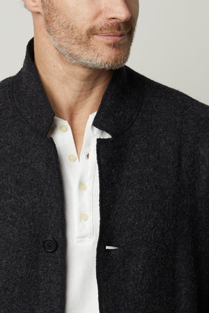 A man wearing a Bowen Boiled Wool Blend Jacket by Velvet by Graham & Spencer with front patch pockets and a white shirt.
