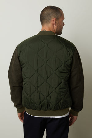 The back view of a man wearing a Velvet by Graham & Spencer MAISON quilted jacket that combines style and functionality.