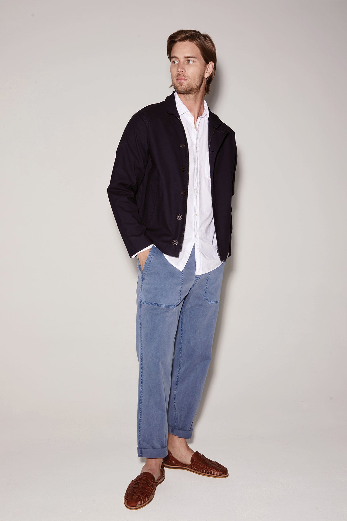 A man wearing a white shirt and Velvet by Graham & Spencer's TOBY SANDED TWILL PANT.-36212324794561