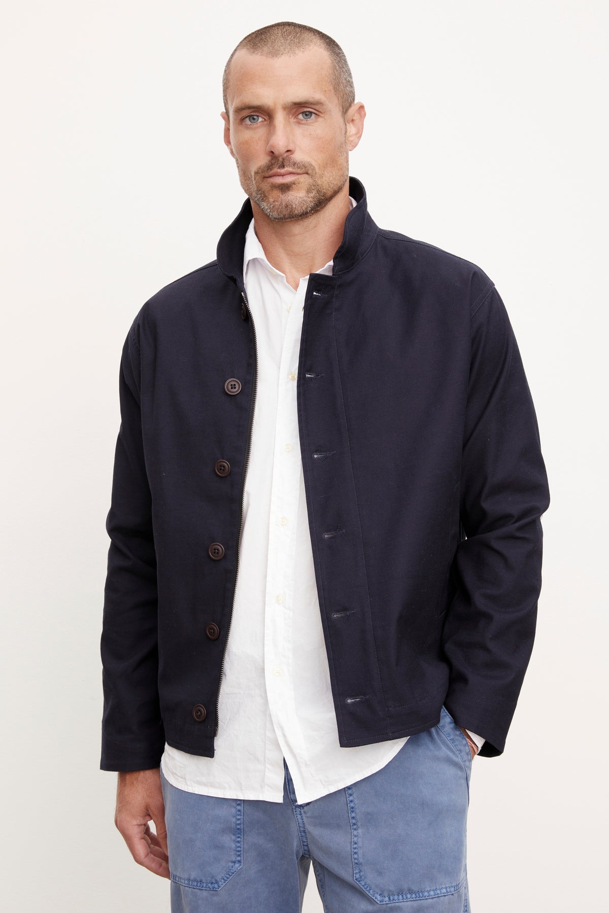 A man wearing a Velvet by Graham & Spencer MARLON ZIP-UP JACKET and blue jeans.-36212320829633