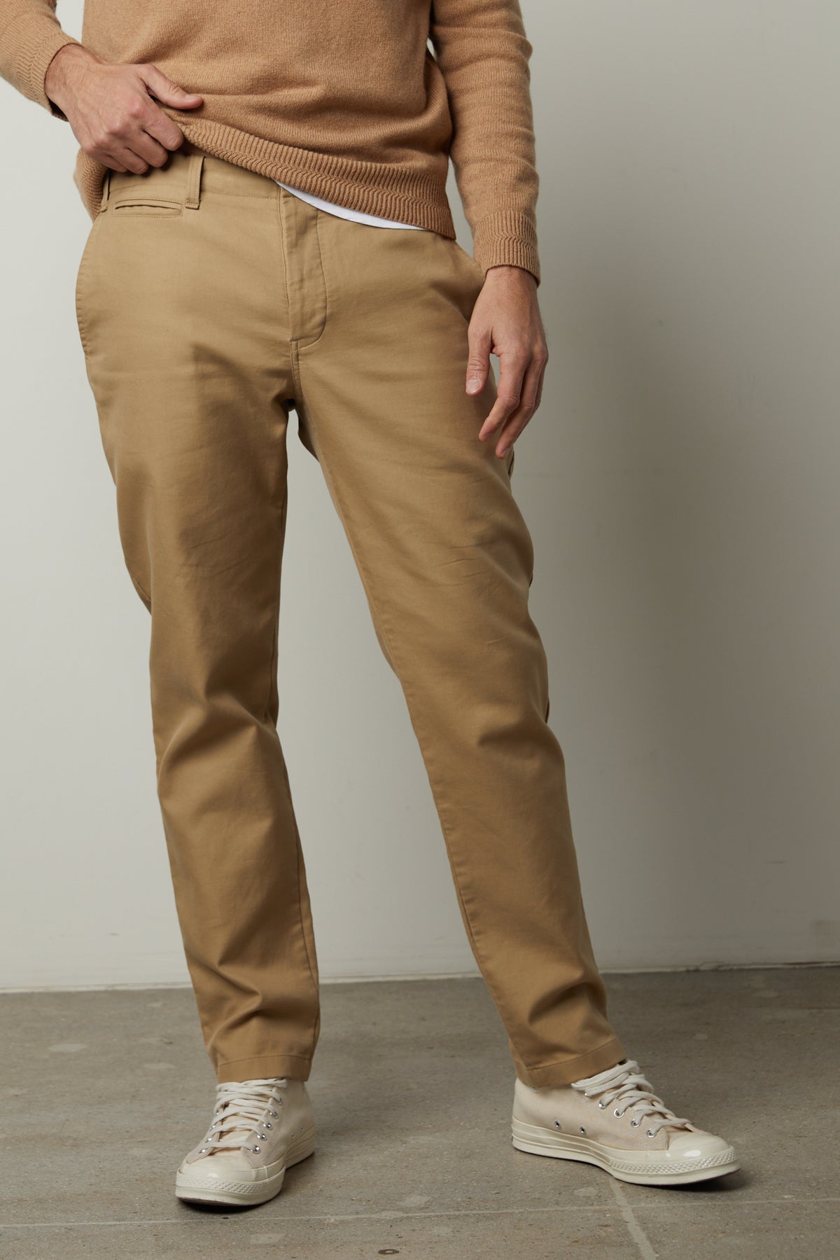 A man wearing Velvet by Graham & Spencer tan AIDEN COTTON TWILL PANTS and a cotton woven sweater.-26855326482625