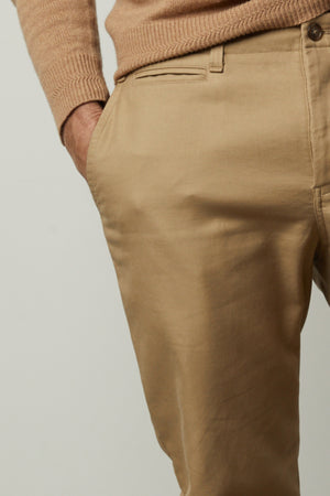A man wearing AIDEN COTTON TWILL pants by Velvet by Graham & Spencer and a cotton woven sweater.