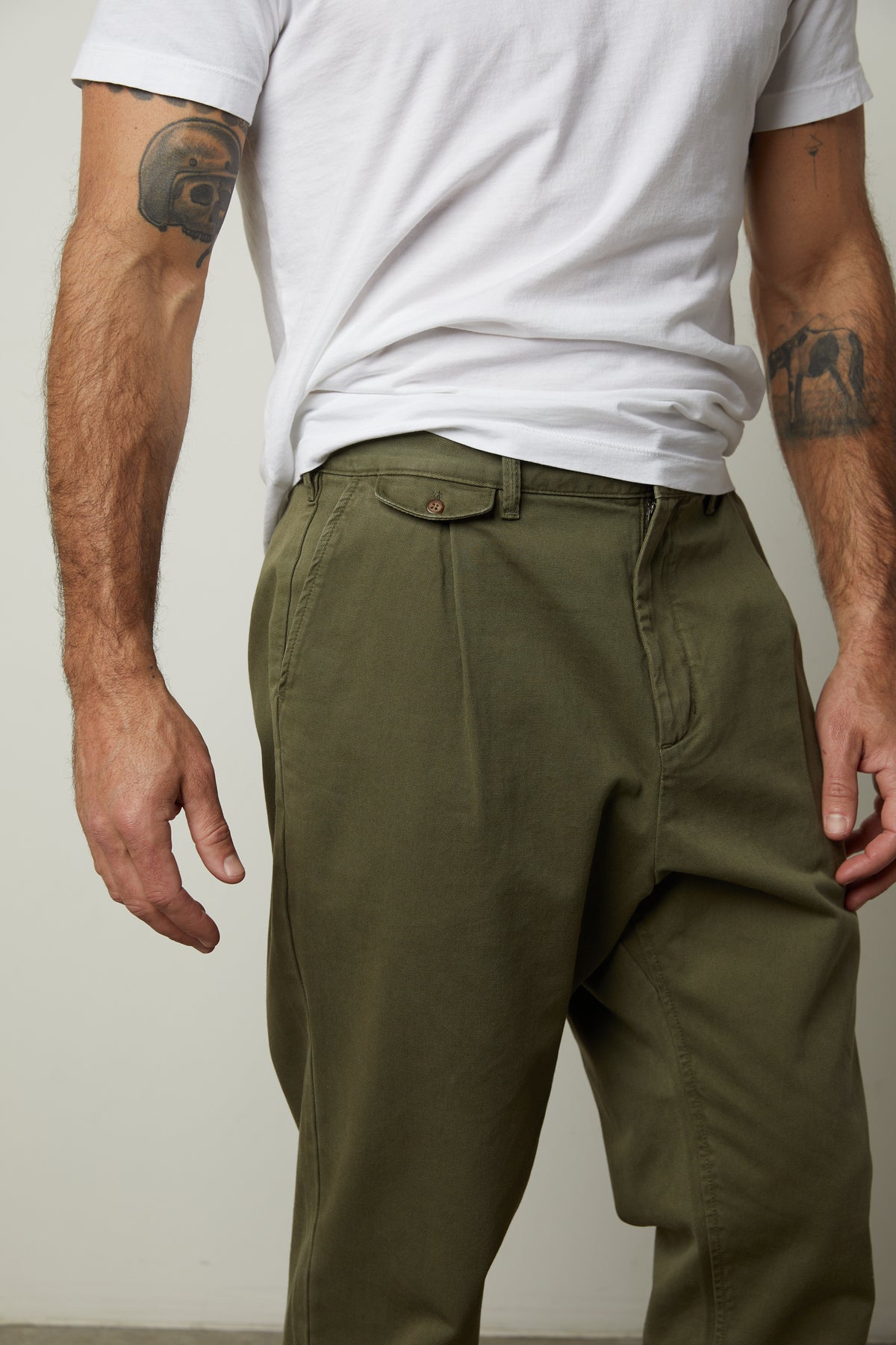 A man wearing Velvet by Graham & Spencer VINNY COTTON CANVAS PANT khaki pants and a white t-shirt with straight-fit leg.-26855321698497