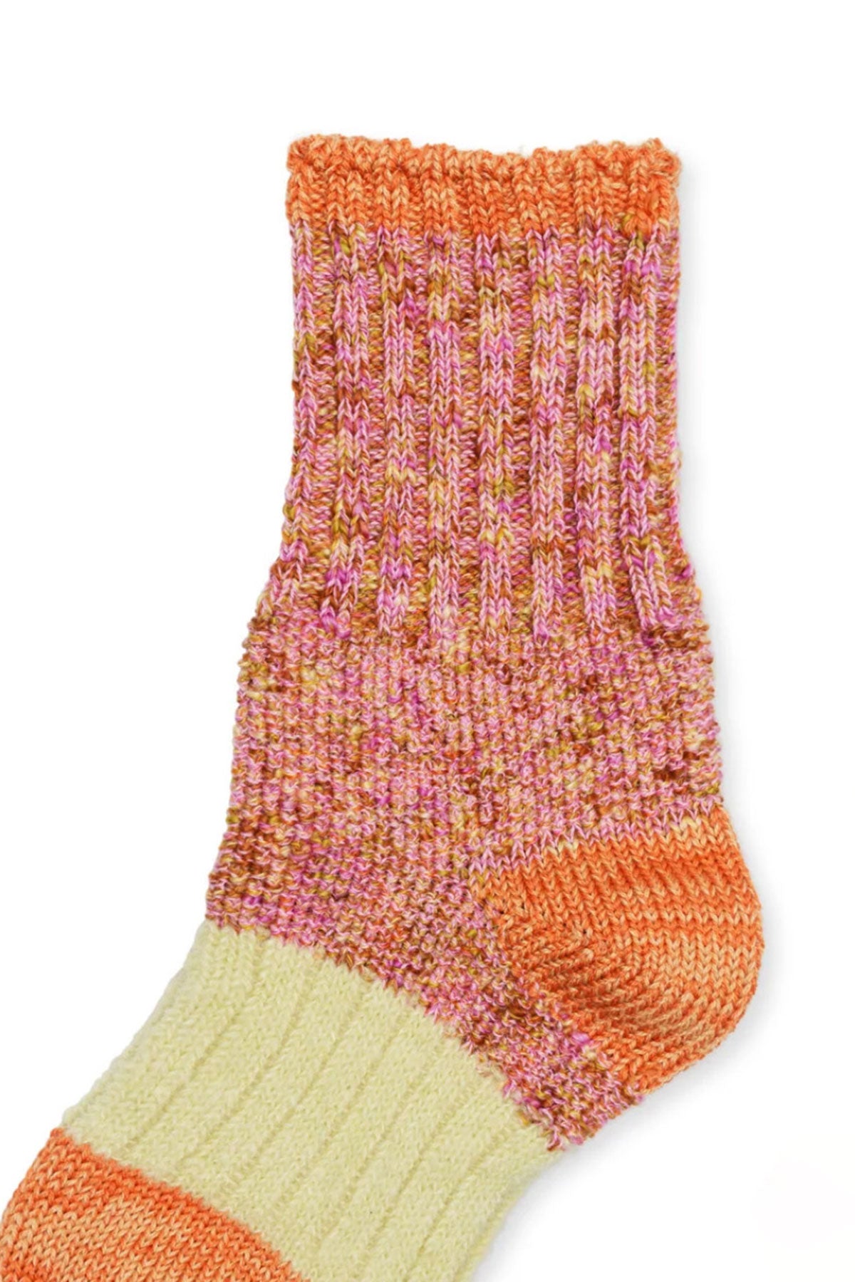 The PIXIE DAPPLE CREW SOCKS BY HANSEL FROM BASEL from Hansel From Basel feature a colorful knitted design with a ribbed upper section in shades of orange, pink, and red, and a beige section with an orange stripe near the ankle. Embrace their unique designs in legwear for vibrant style.-35711045697729