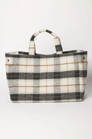 The PLAID TOTE by Velvet by Graham & Spencer is a rectangular plaid bag in black, white, and beige, made from a polyester wool blend with two short handles and side snap closures—ideal as a stylish weekender. Displayed on a plain background.