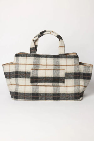 The PLAID TOTE by Velvet by Graham & Spencer features a black, brown, and cream plaid on a soft polyester wool blend with two handles—ideal as a stylish weekender bag.