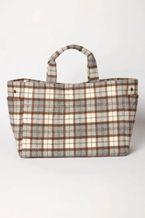 The PLAID TOTE by Velvet by Graham & Spencer features a brown, gray, and cream plaid pattern on a white background. Made from a polyester wool blend, this rectangular bag with short handles is a stylish option for weekend getaways.