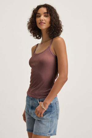 A person with curly brown hair wears the Velvet by Graham & Spencer INIKU POINTELLE TANK TOP in mauve and denim shorts, standing against a plain light background.